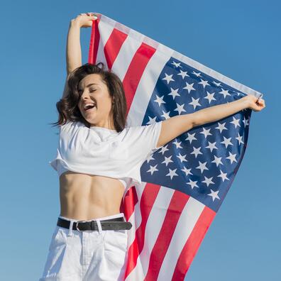 brunette_woman_in_white_clothes_holding_big_usa_flag.jpg brunette_woman_in_white_clothes_holding_big_usa_flag.jpg